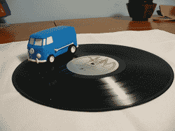 vw camper van driving on an vinyl record